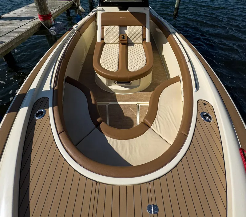 Slide: The Image of 2019 Chris-Craft 30 Catalina boat interior with elegant tan seating and wood finish. - 11