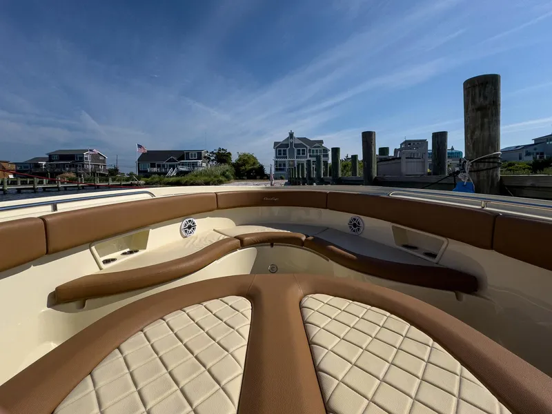 Slide: The Image of 2019 Chris-Craft 30 Catalina boat interior with tan leather seating at a dock. - 13