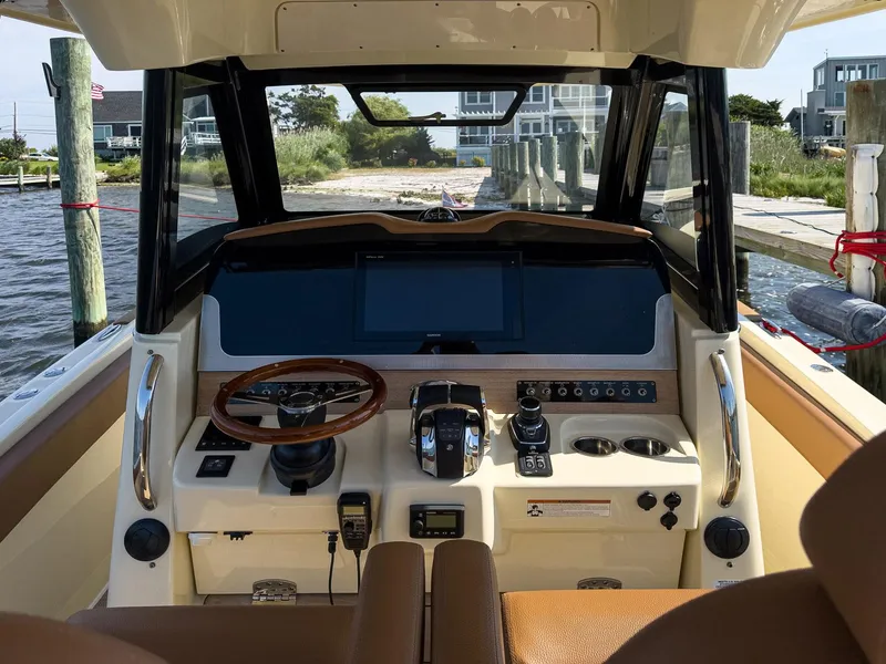 Slide: The Image of 2019 Chris-Craft 30 Catalina helm with modern controls and navigation system. - 16