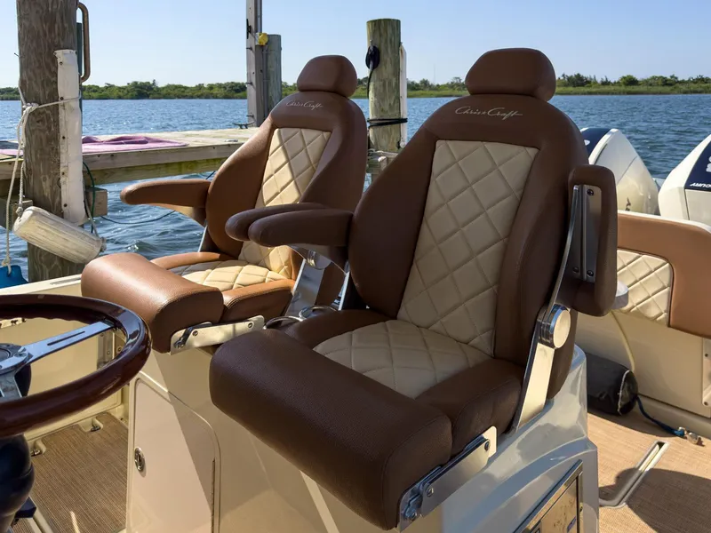 Slide: The Image of Luxurious seating on 2019 Chris-Craft 30 Catalina boat, featuring elegant diamond-stitched upholstery. - 17