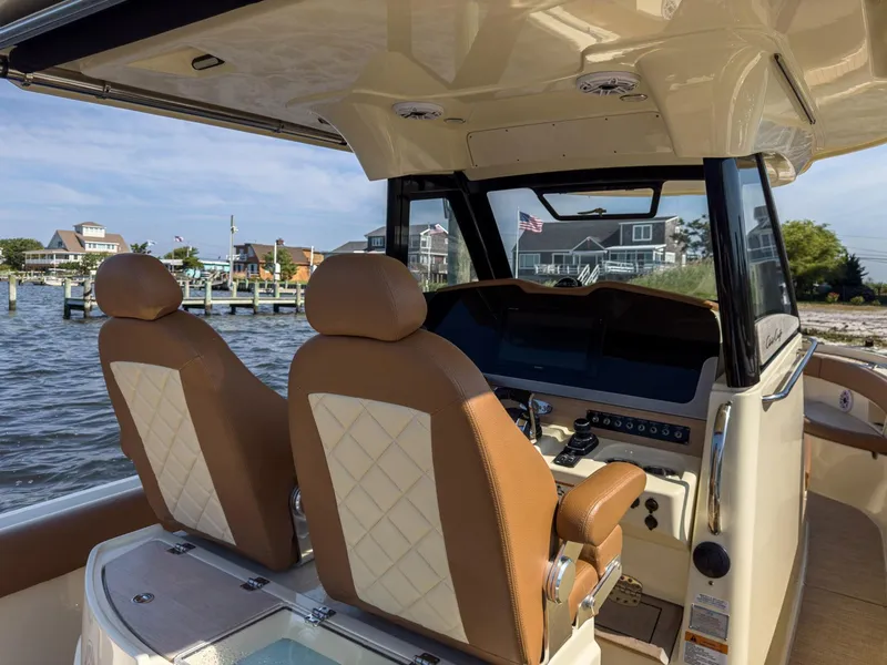 Slide: The Image of Interior of 2019 Chris-Craft 30 Catalina boat with leather seats and dashboard view. - 18