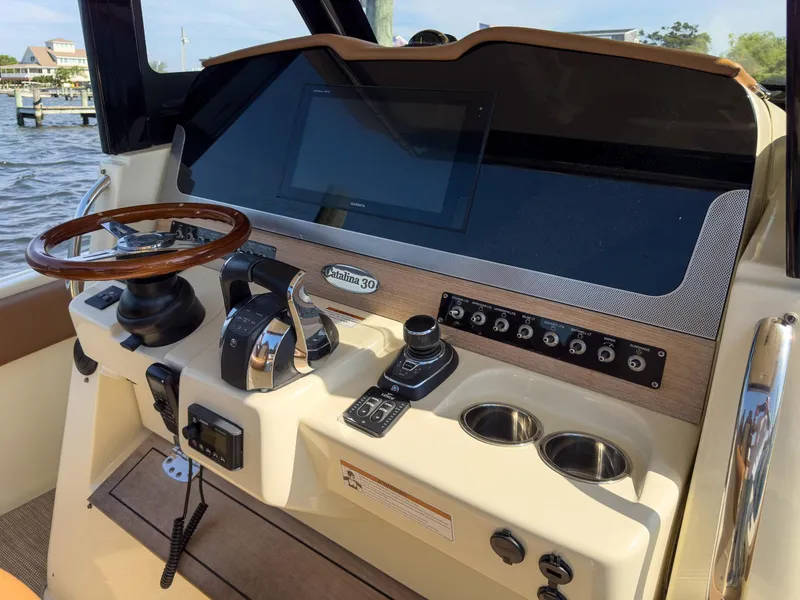 Slide: The Image of 2019 Chris-Craft 30 Catalina helm with modern controls and wooden steering wheel. - 19