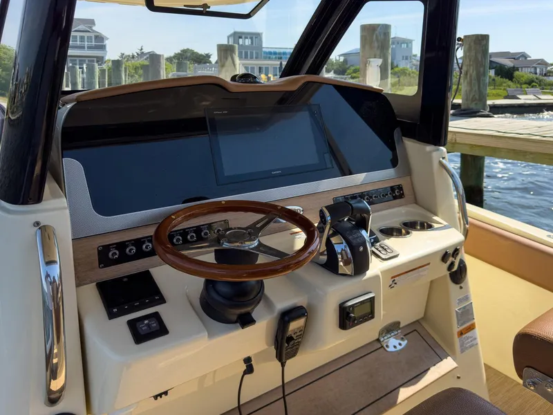 Slide: The Image of 2019 Chris-Craft 30 Catalina helm with modern controls and wooden steering wheel. - 20