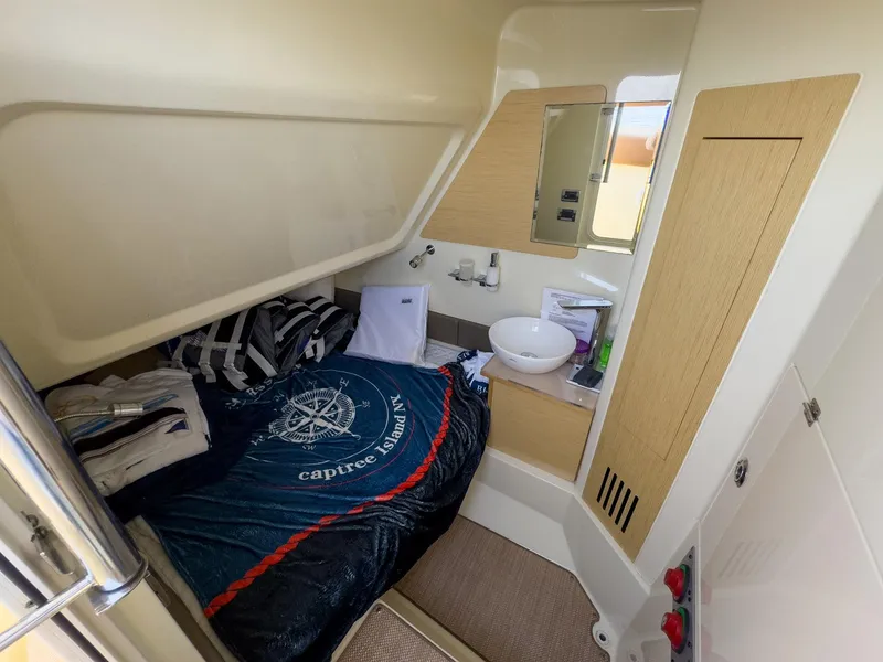 Slide: The Image of 2019 Chris-Craft 30 Catalina cabin interior with bed, sink, and storage. - 23