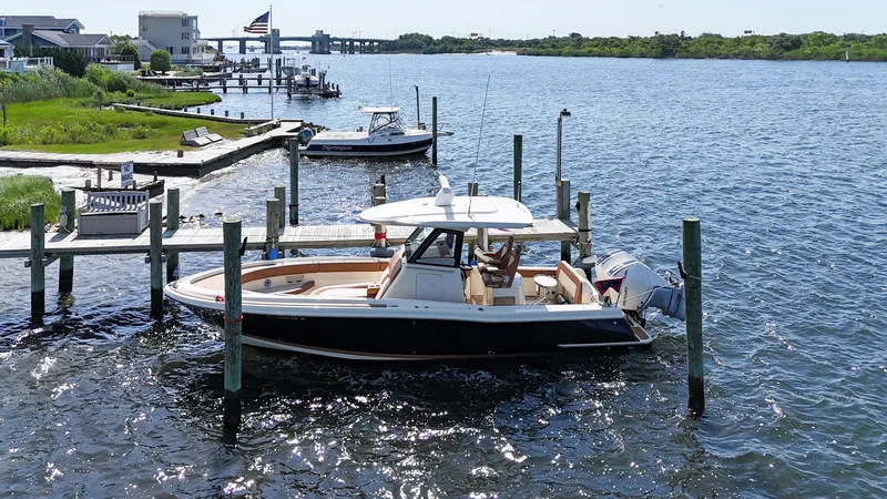 Slide: The Image of 2019 Chris-Craft 30 Catalina docked in a scenic waterfront setting. - 3