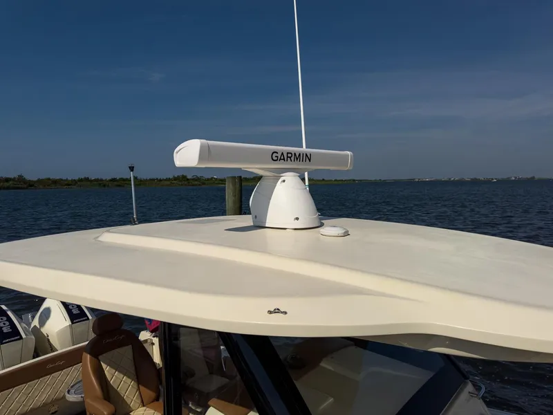 Slide: The Image of 2019 Chris-Craft 30 Catalina with Garmin radar on roof, docked by the water. - 7