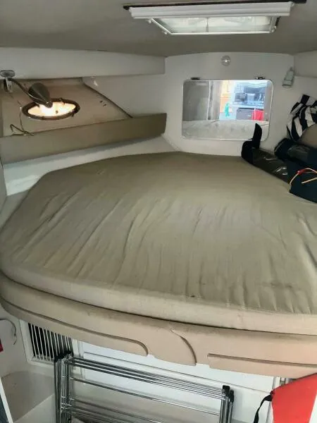Slide: The Image of Interior cabin of 1988 Wellcraft San Remo 43 yacht with bed and window. - 12