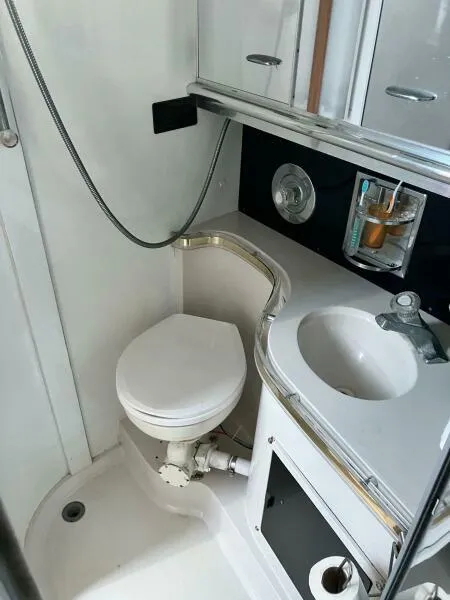 Slide: The Image of 1988 Wellcraft San Remo 43 yacht bathroom with toilet, sink, and shower. - 13