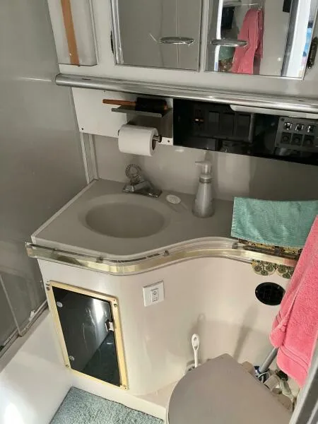 Slide: The Image of 1988 Wellcraft San Remo 43 bathroom with sink, mirror, and storage. - 17