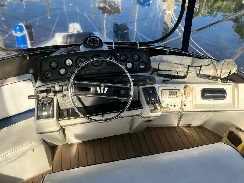 Slide: The Image of 1988 Wellcraft San Remo 43 boat helm with steering wheel and control panel. - 5