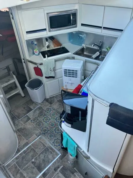 Slide: The Image of 1988 Wellcraft San Remo 43 yacht interior kitchen with modern appliances and tiled flooring. - 9