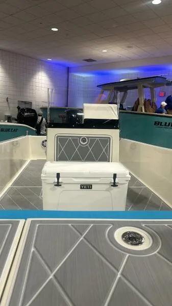 Slide: The Image of 2024 BlueCat 17 LF boat interior with Yeti cooler, showcased indoors. - 5