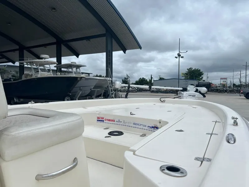 Slide: The Image of 2012 ShearWater 23LTZ boat at marina, overcast sky, docked alongside other vessels. - 11