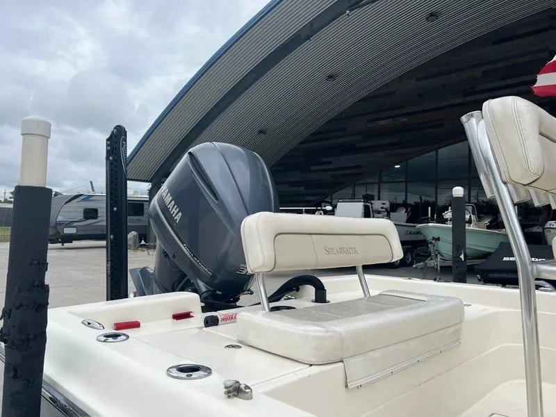 Slide: The Image of 2012 ShearWater 23LTZ boat with Yamaha engine, docked near modern building. - 12
