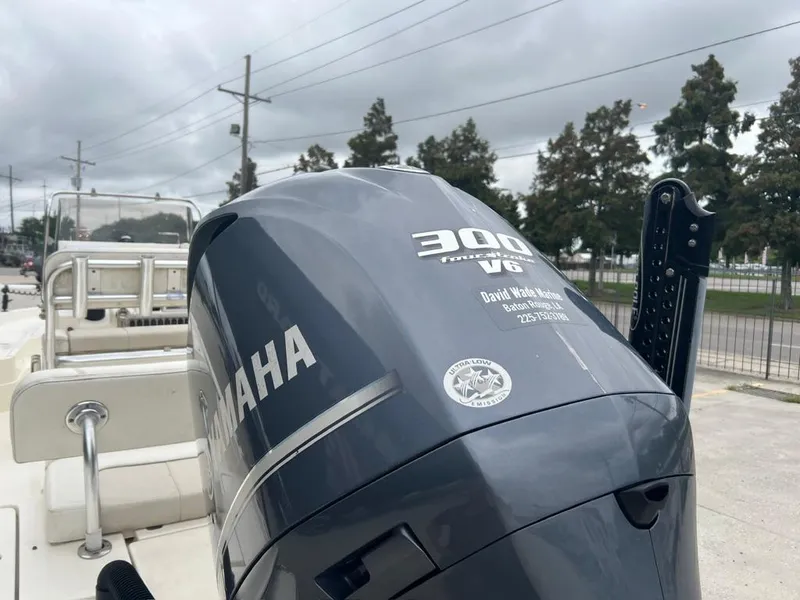 Slide: The Image of Yamaha 300 V6 outboard motor on 2012 ShearWater 23LTZ boat, parked outdoors. - 13