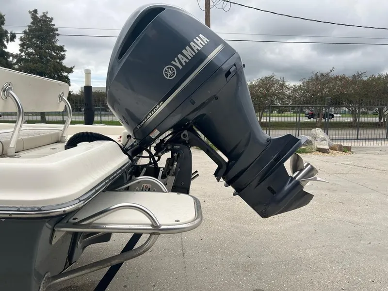 Slide: The Image of 2012 ShearWater 23LTZ boat with Yamaha outboard motor, parked on concrete. - 14