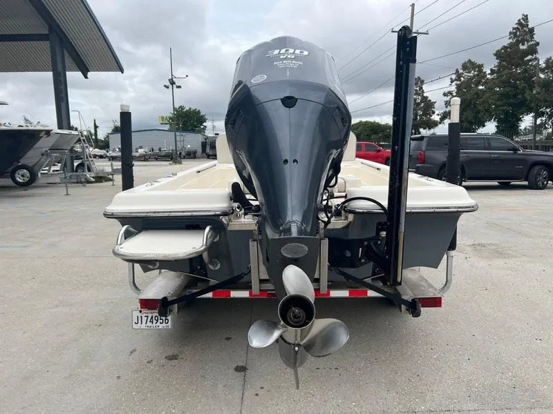 Slide: The Image of 2012 ShearWater 23LTZ boat rear view with outboard motor and trailer. - 3