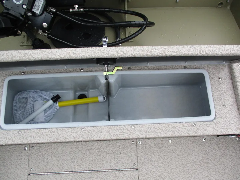 Slide: The Image of 2025 Lund Alaskan 1675 Tiller boat storage compartment with fishing net and handle. - 3