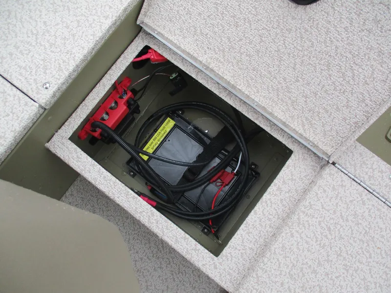 Slide: The Image of 2025 Lund Alaskan 1675 Tiller boat battery compartment with wiring and connections. - 4