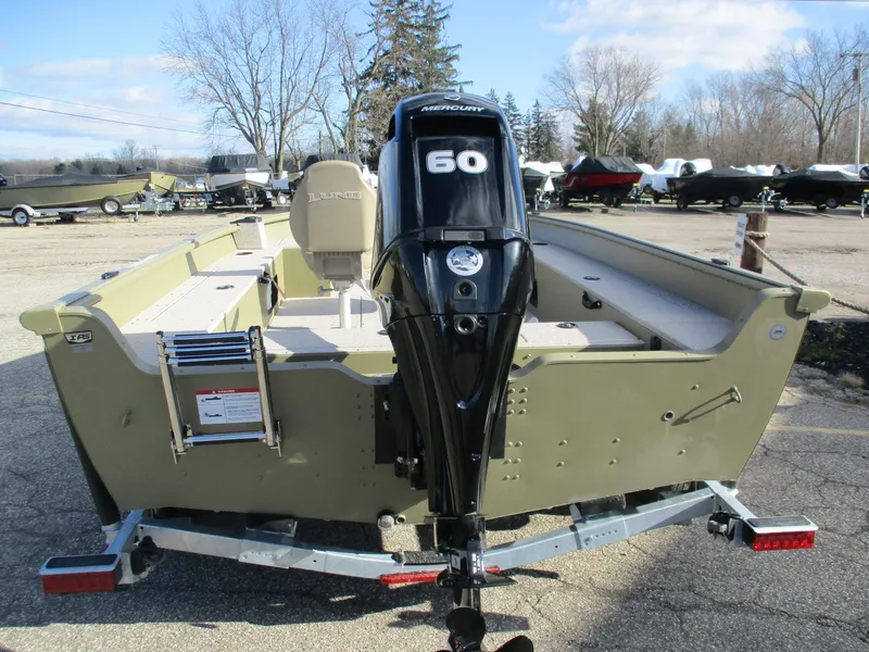 Slide: The Image of 2025 Lund Alaskan 1675 Tiller boat with Mercury 60 engine, parked outdoors. - 7