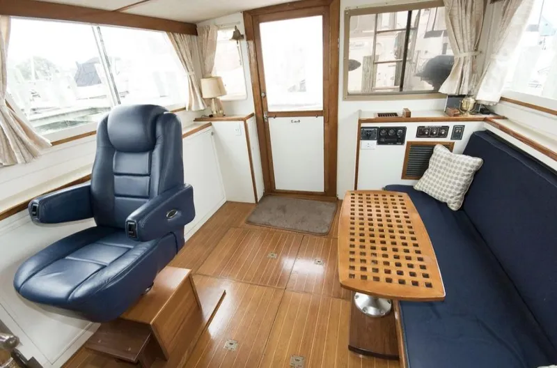 Slide: The Image of Interior of a 1978 Morton & Hersloff 36 boat with blue seating and wooden accents. - 10