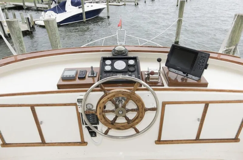 Slide: The Image of Helm of 1978 Morton & Hersloff 36 boat with wooden wheel and navigation equipment. - 4