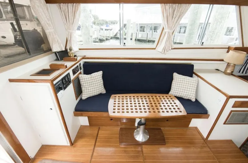 Slide: The Image of Interior of a 1978 Morton & Hersloff 36 boat with wooden flooring and cushioned seating. - 8