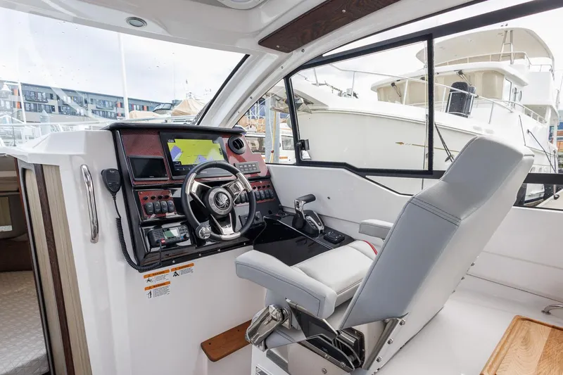 Slide: The Image of Interior of 2025 Solara S-250 Coupe boat with modern steering and navigation system. - 21