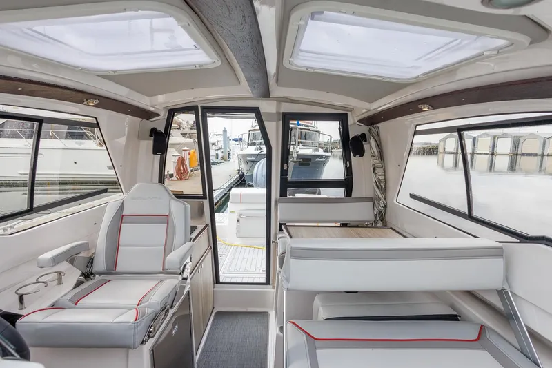 Slide: The Image of Interior of 2025 Solara S-250 Coupe boat, featuring modern seating and panoramic windows. - 28
