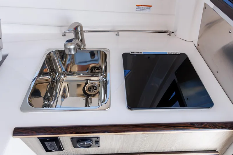 Slide: The Image of Compact kitchen area in 2025 Solara S-250 Coupe with sink and stove. - 32