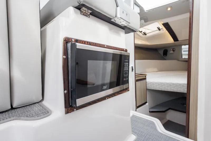 Slide: The Image of Interior of 2025 Solara S-250 Coupe featuring a built-in microwave and cozy sleeping area. - 33