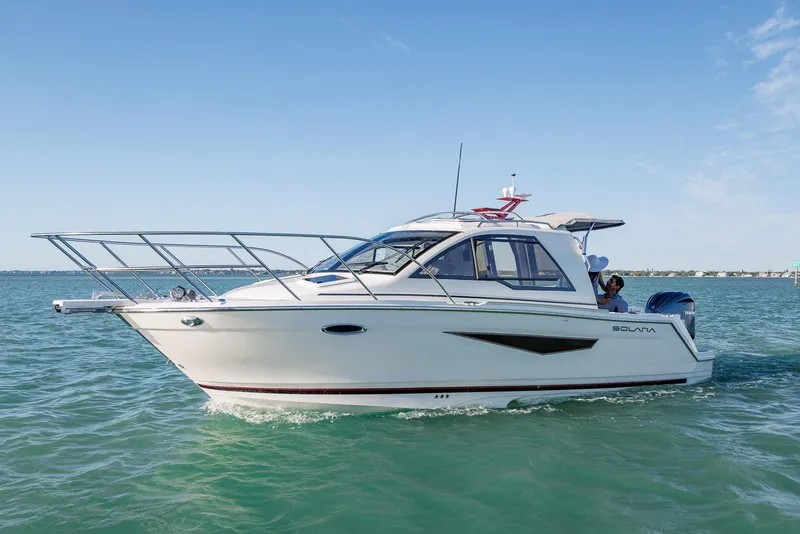 The Image of 2025 Solara S-250 Coupe boat cruising on clear blue water. - 0