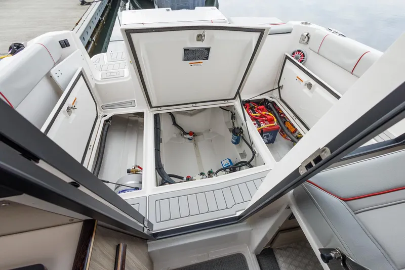 Slide: The Image of 2025 Solara S-250 Coupe boat interior with open storage compartments and visible wiring. - 19