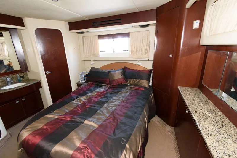 Slide: The Image of Luxurious bedroom interior of 2006 Sea Ray 40 Motor Yacht with elegant bedding and wood finishes. - 17