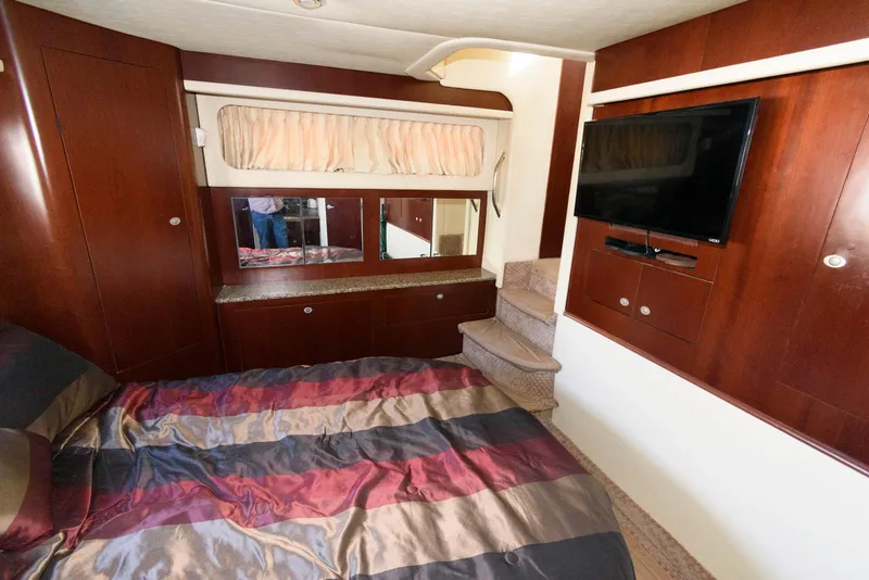 Slide: The Image of Luxurious 2006 Sea Ray 40 Motor Yacht bedroom with TV and elegant wood finishes. - 18