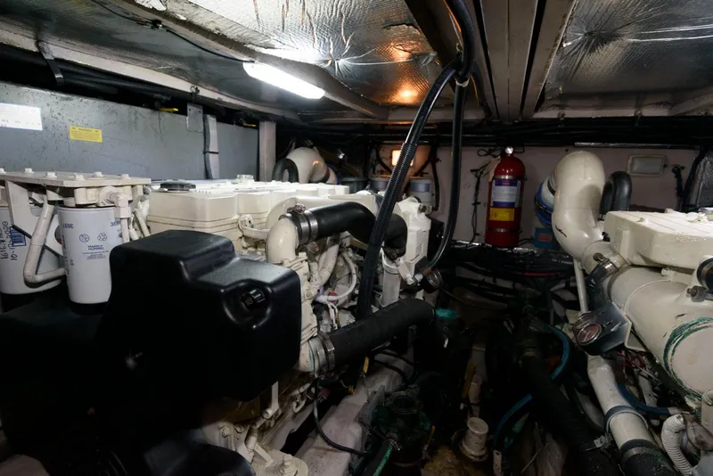 Slide: The Image of Engine room of 2006 Sea Ray 40 Motor Yacht, featuring dual engines and fire extinguisher. - 23