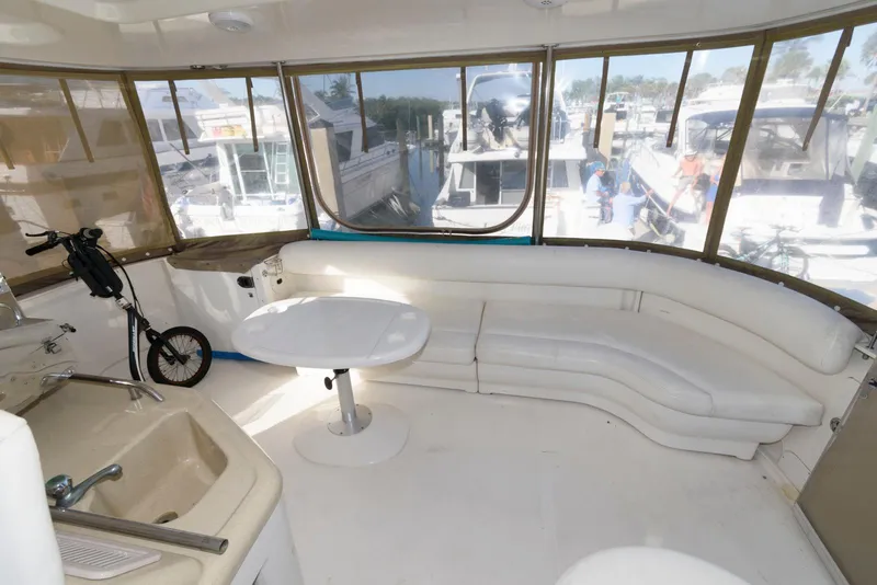 Slide: The Image of Interior of 2006 Sea Ray 40 Motor Yacht with white seating and table. - 4