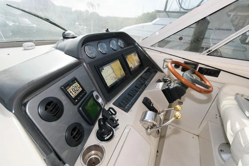 Slide: The Image of 2006 Sea Ray 40 Motor Yacht helm with navigation screens and controls. - 8