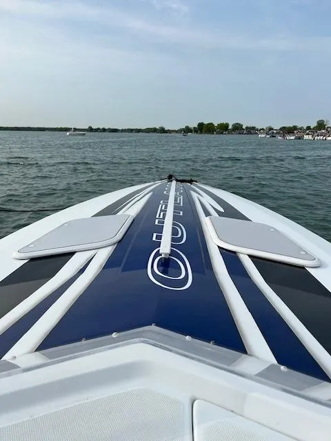Slide: The Image of 2006 Baja 35 Outlaw speedboat on open water, showcasing sleek design and vibrant graphics. - 10