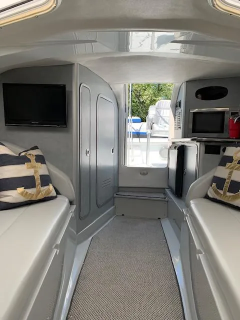 Slide: The Image of Interior of 2006 Baja 35 Outlaw boat with modern amenities and nautical decor. - 20