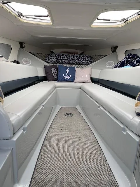 Slide: The Image of 2006 Baja 35 Outlaw cabin interior with nautical-themed cushions and sleek design. - 21