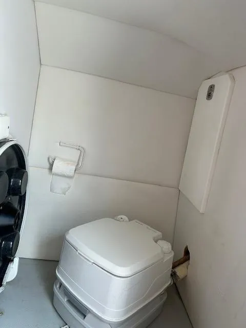 Slide: The Image of Compact marine toilet in 2006 Baja 35 Outlaw boat cabin. - 22