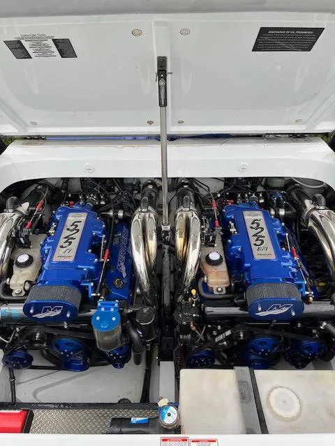 Slide: The Image of 2006 Baja 35 Outlaw boat engine compartment with dual blue engines. - 24