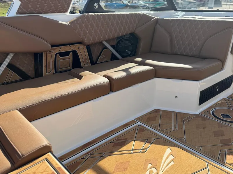 Slide: The Image of Luxurious interior of 2025 Tigé 22RZX boat with brown leather seating and stylish flooring. - 10