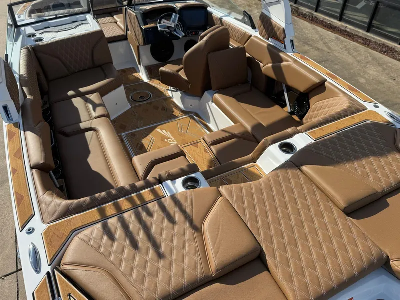 Slide: The Image of 2025 Tigé 22RZX boat interior with luxurious brown leather seating and modern dashboard. - 13
