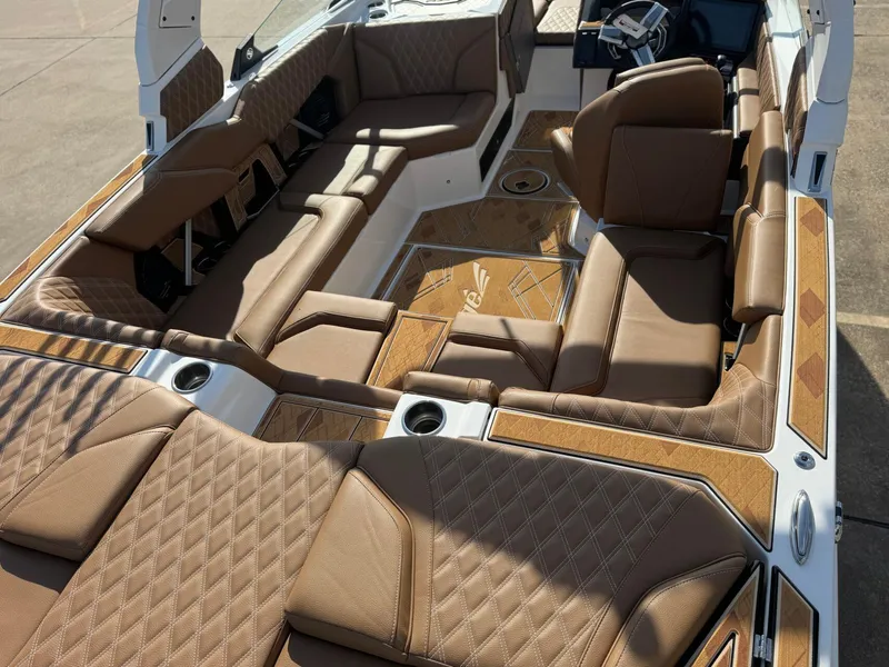 Slide: The Image of 2025 Tigé 22RZX boat interior with luxurious brown leather seating and modern design. - 6
