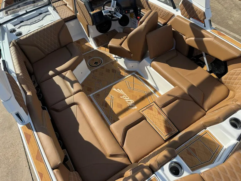 Slide: The Image of 2025 Tigé 22RZX boat interior with luxurious brown leather seating and stylish design. - 7