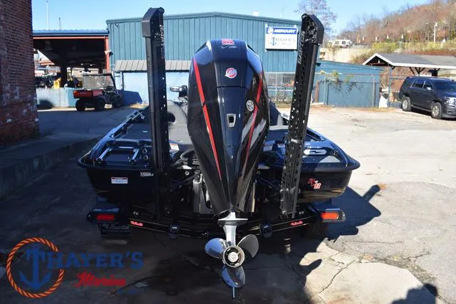 Slide: The Image of 2025 Bass Cat Puma STS boat with powerful outboard motor in a marina setting. - 10