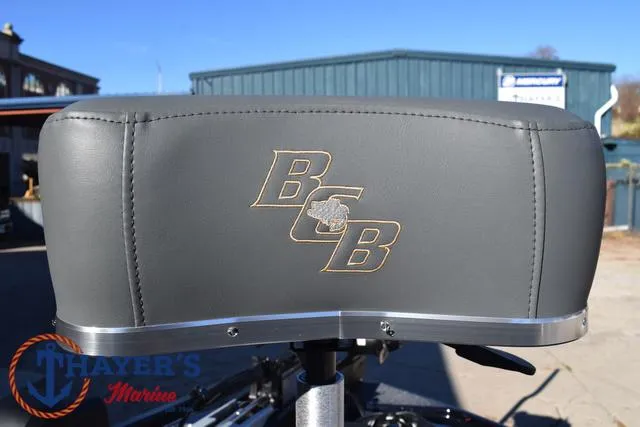 Slide: The Image of Bass Cat Puma STS 2025 boat seat with logo, outdoors at Thayer's Marine. - 12
