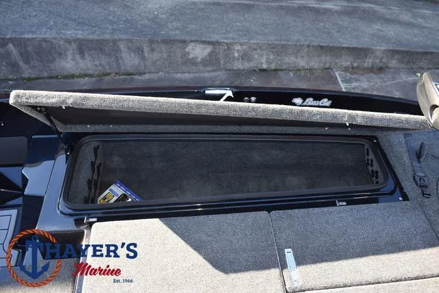 Slide: The Image of 2025 Bass Cat Puma STS storage compartment, open lid, Thayer's Marine logo visible. - 14